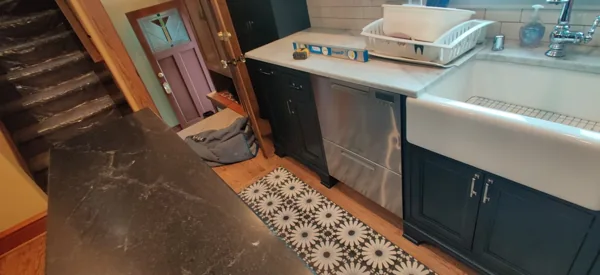 A stainless steel dishwasher fitted beneath the kitchen counter.