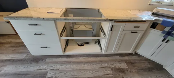 An existing cooktop opening and cabinet space prepared for appliance and downdraft replacement