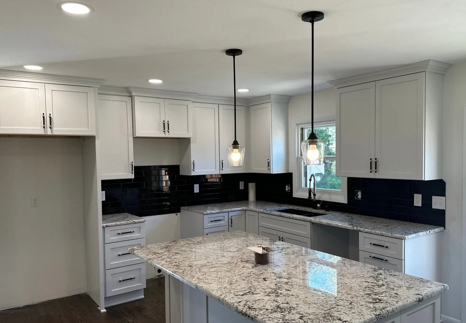 White cabinetry and dark tile in our Cedarburg remodel